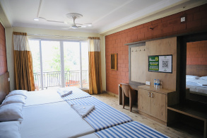 Room view at Hotel Parijatha Inn — clean room with attached bathroom