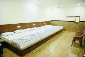 Corridor at Hotel Parijatha Inn — well-lit and clean